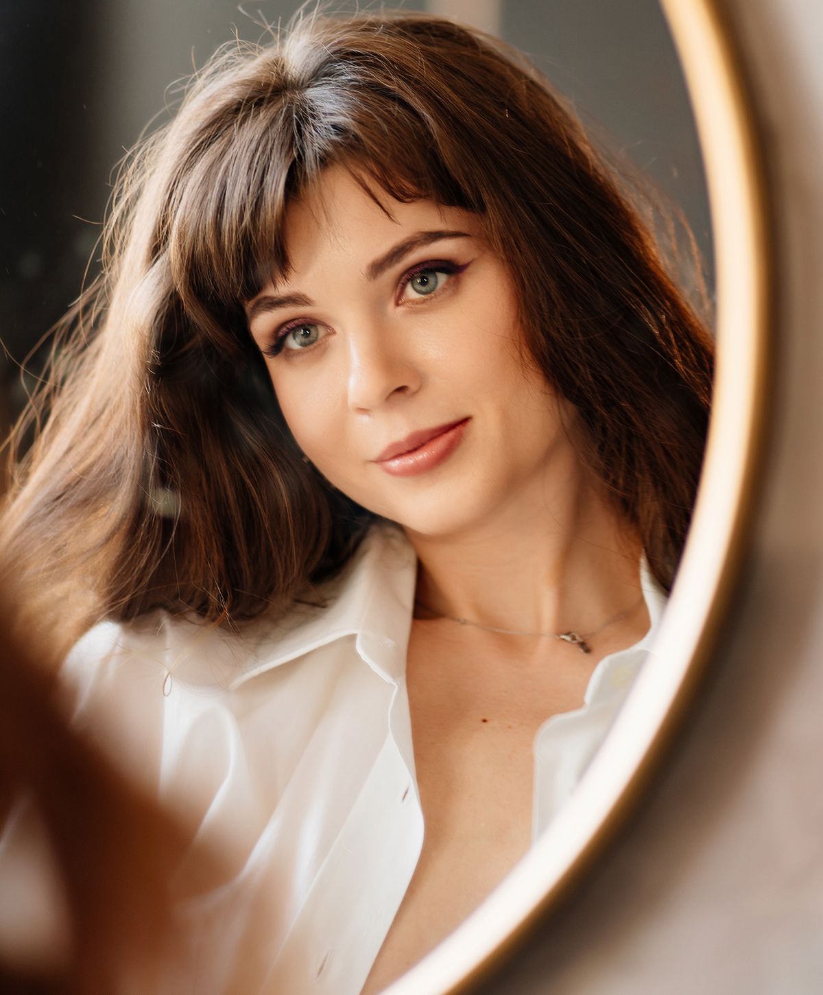 Woman wearing elegant jewelry and stylish attire.