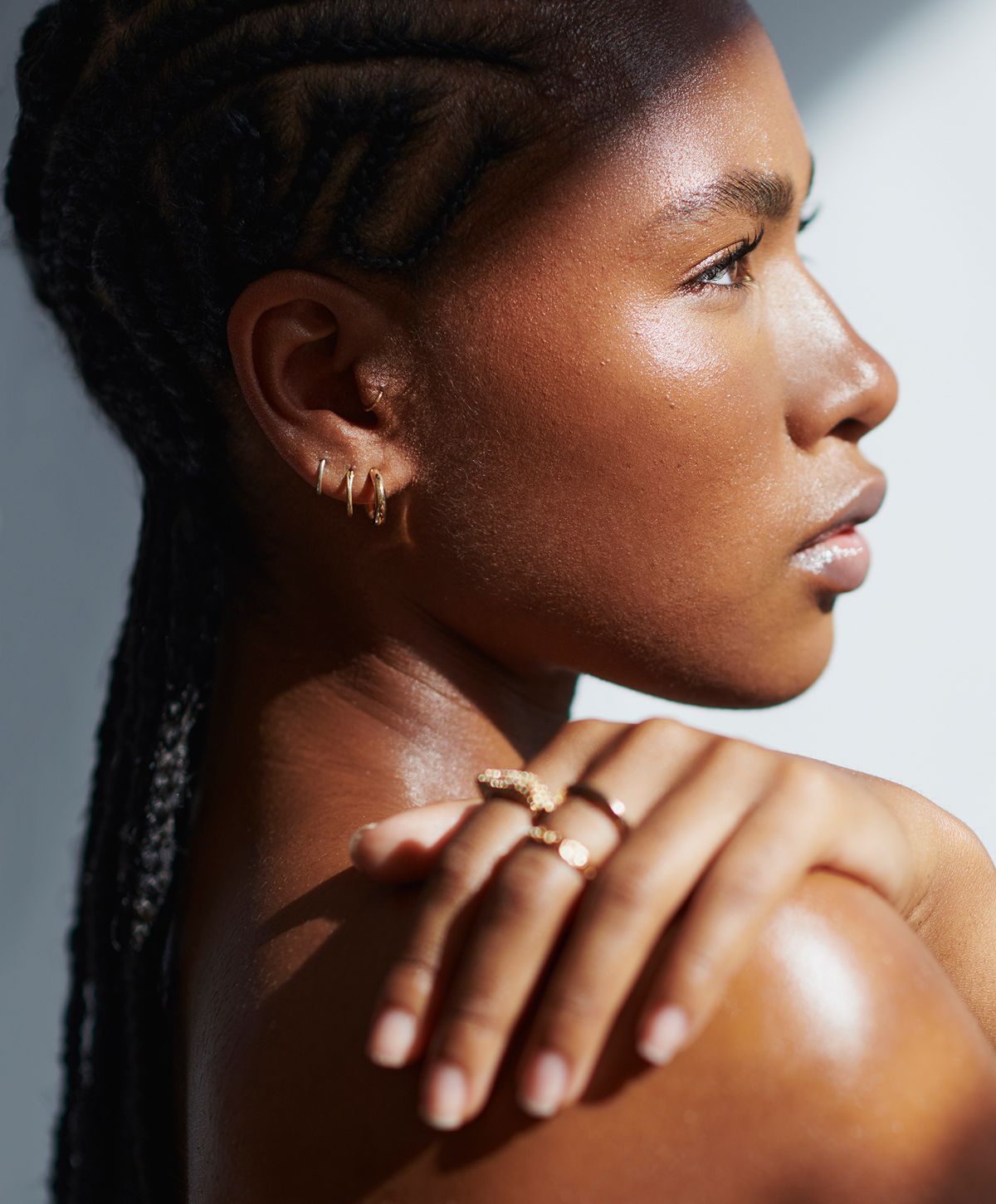 Woman wearing elegant jewelry and stylish attire.