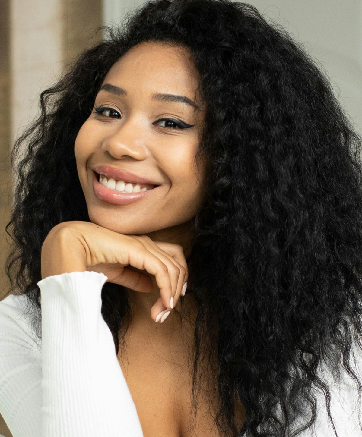 Person brushing legs while sitting in bathroom.