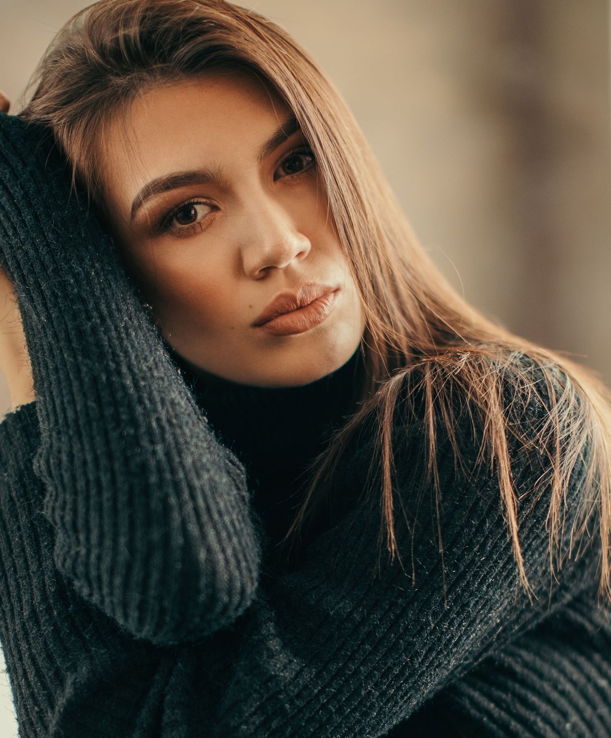 Woman wearing elegant jewelry and stylish attire.