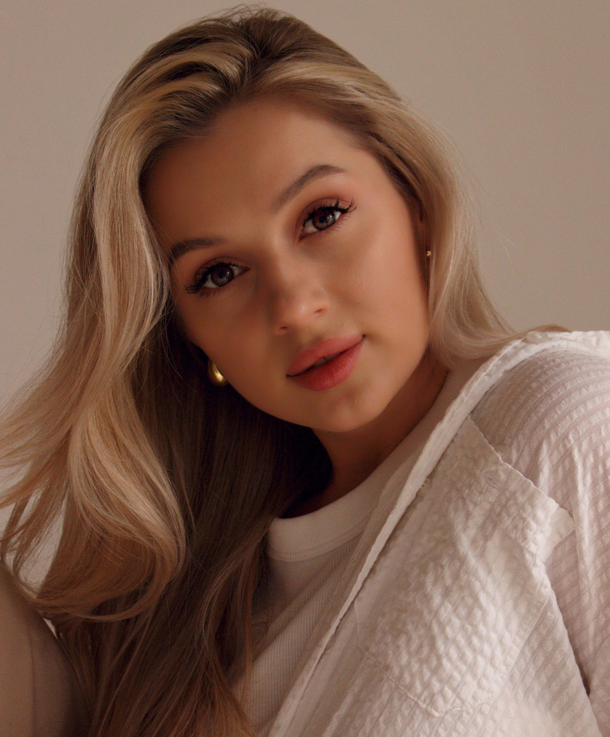 Woman wearing elegant jewelry and stylish attire.