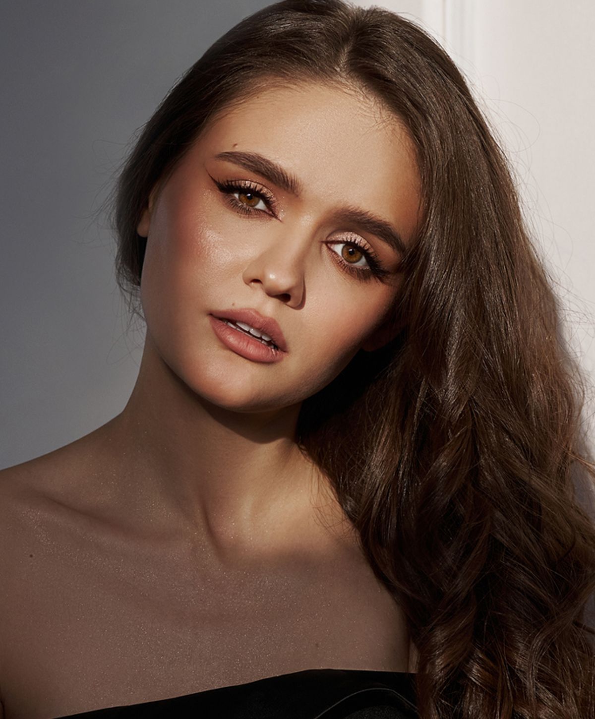 Woman wearing elegant jewelry and stylish attire.