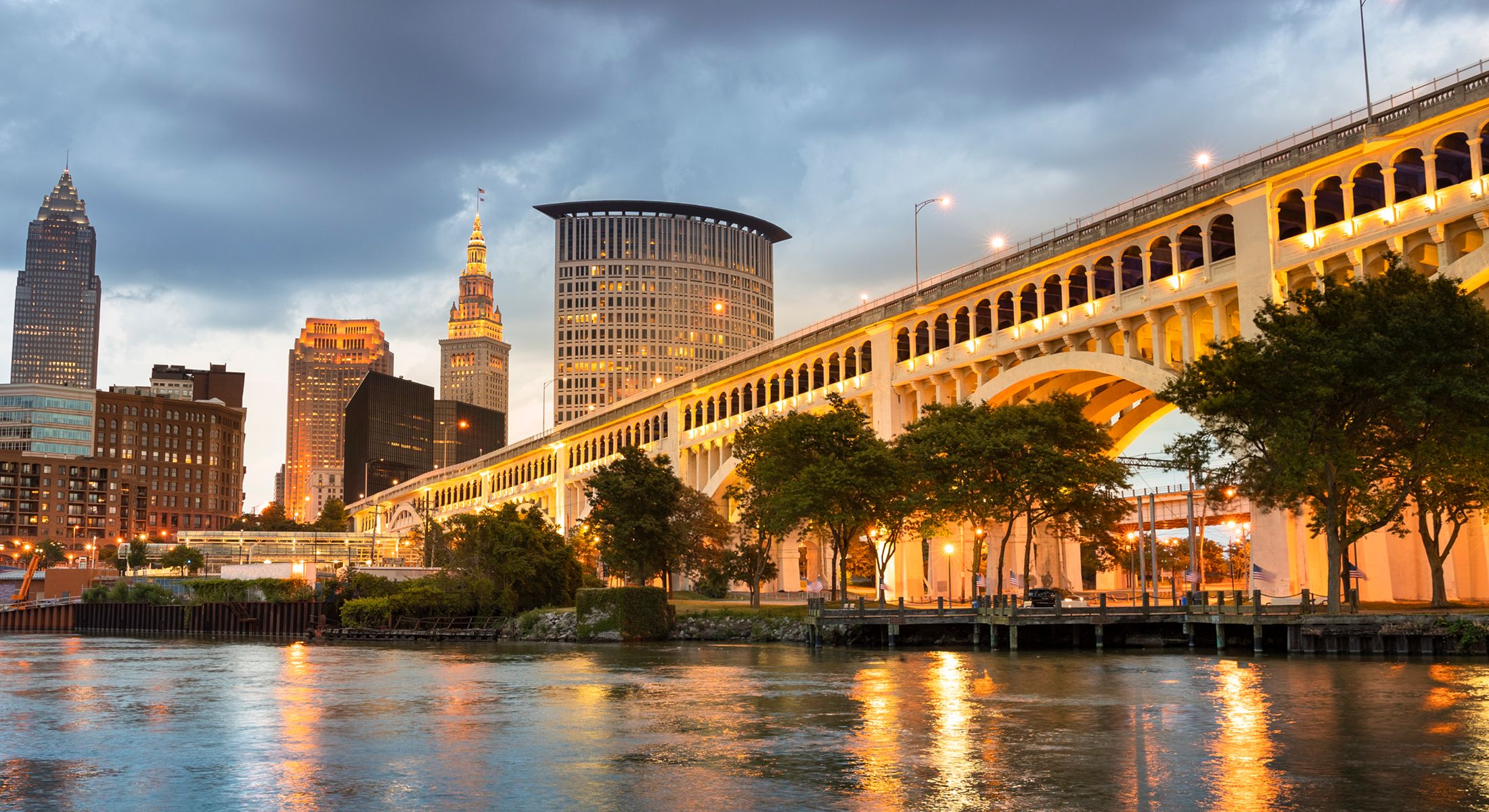 Cleveland skyline with illuminated bridge at dusk.