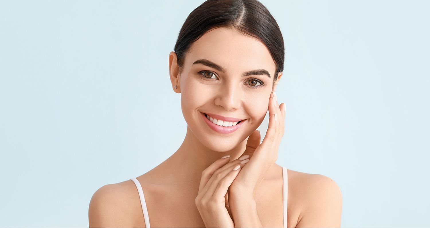 Woman smiling with soft, glowing skin.