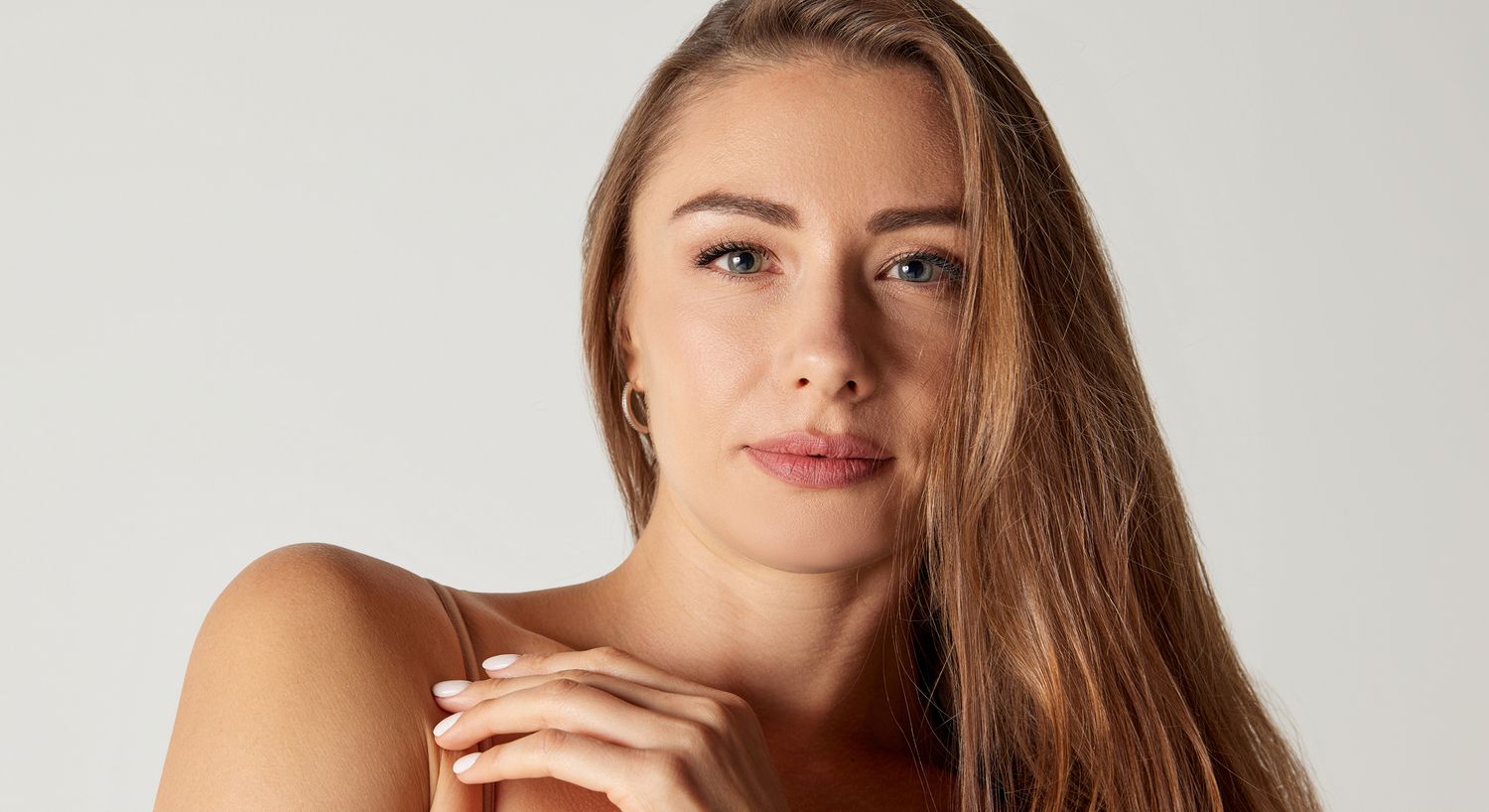 Woman with long hair looking directly at camera.