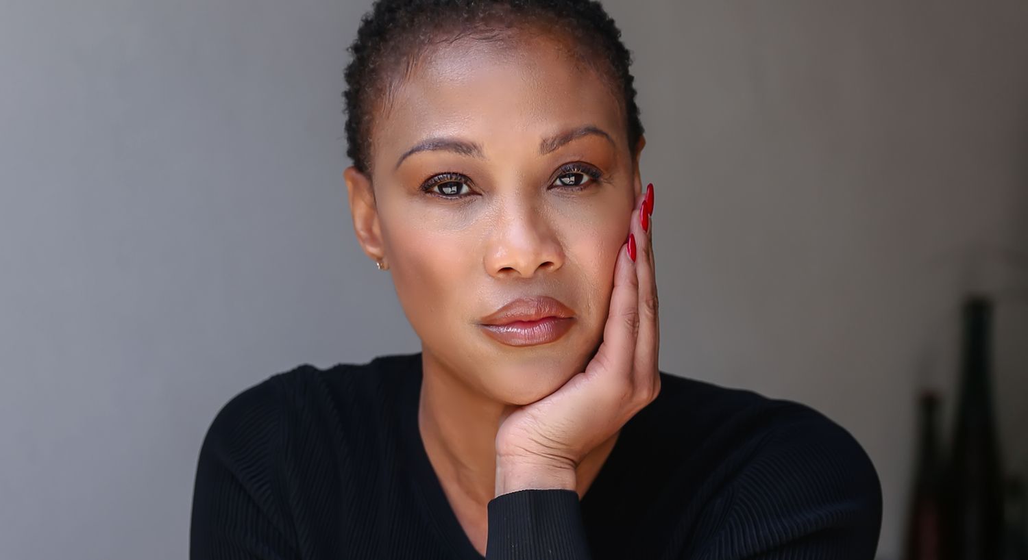 Person resting chin on hand, thoughtful expression.